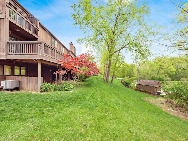 view of yard with a deck and central AC