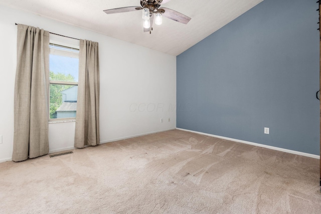 carpeted empty room featuring visible vents, baseboards, ceiling fan, and lofted ceiling