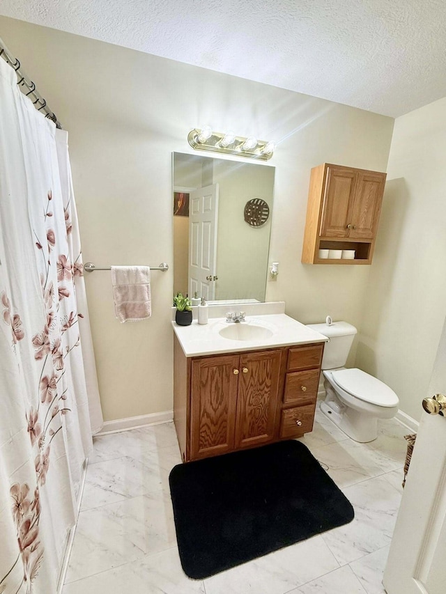 bathroom featuring vanity, marble finish floor, toilet, a shower with shower curtain, and a textured ceiling