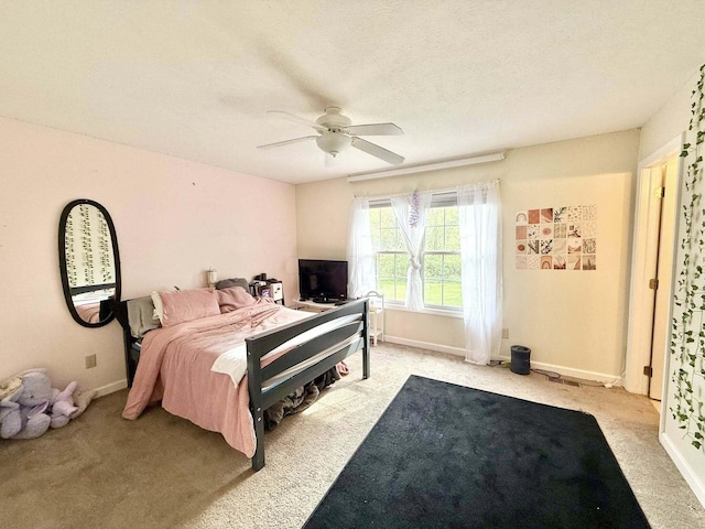 carpeted bedroom with baseboards, a ceiling fan, and a textured ceiling