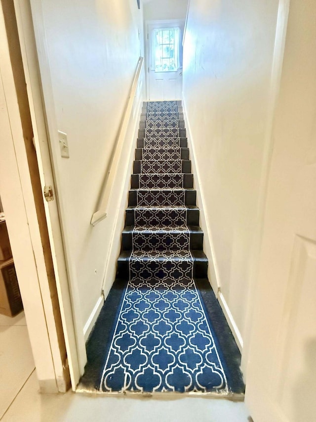 stairs featuring baseboards