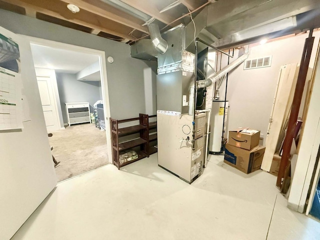 below grade area with heating unit, gas water heater, and visible vents