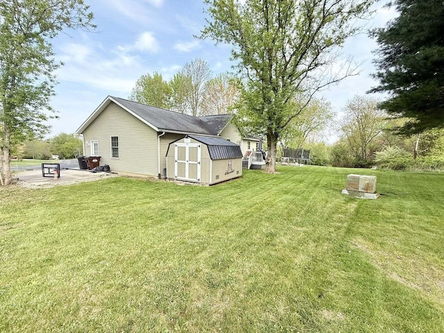 exterior space featuring an outdoor structure, a yard, a storage shed, and a patio