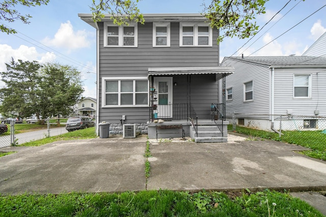 view of front of house with fence and central AC unit