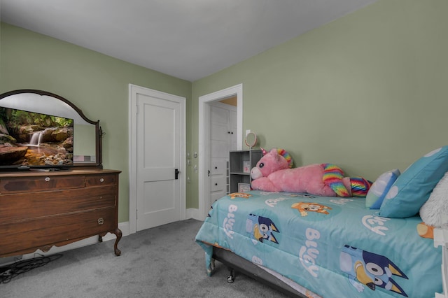 bedroom featuring baseboards and carpet