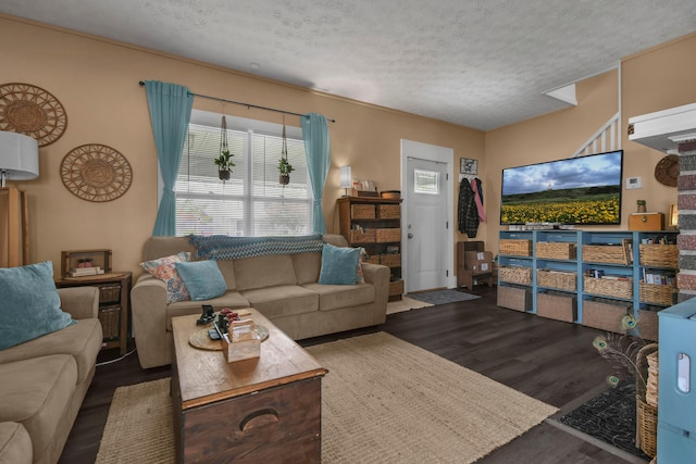 living area with a textured ceiling and wood finished floors