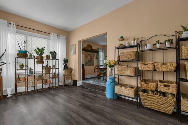 living area featuring baseboards and wood finished floors