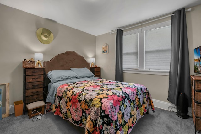 bedroom with carpet floors and baseboards