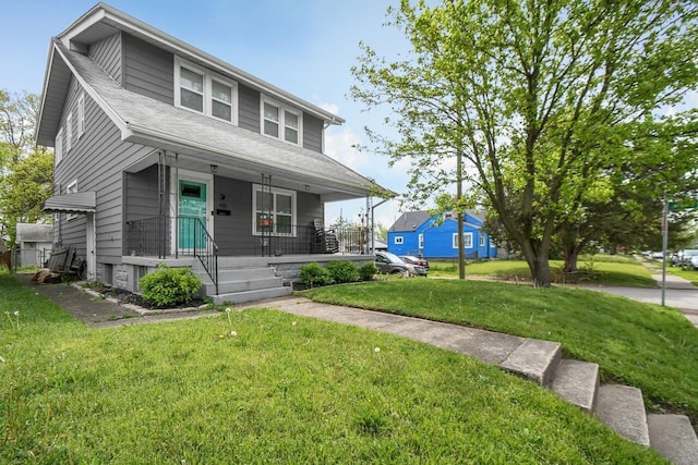 bungalow-style home with covered porch and a front yard