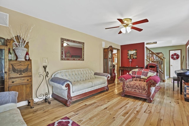 3615 Dragoo Rd, Nashport, OH 43830 - living room featuring stairs, ceiling fan, and light wood-style flooring