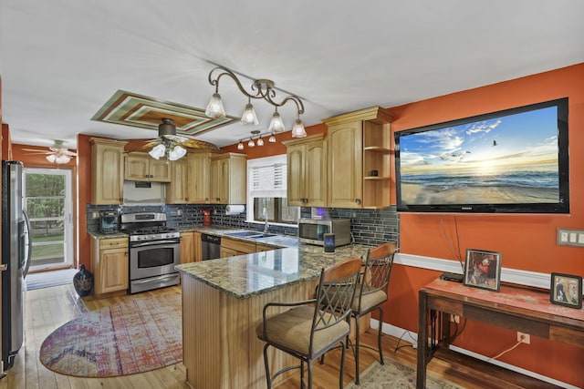 3615 Dragoo Rd, Nashport, OH 43830 - kitchen featuring a peninsula, ceiling fan, tasteful backsplash, a sink, and appliances with stainless steel finishes