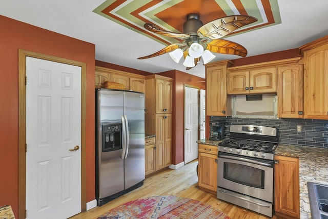 3615 Dragoo Rd, Nashport, OH 43830 - kitchen featuring a ceiling fan, appliances with stainless steel finishes, tasteful backsplash, stone countertops, and light wood finished floors