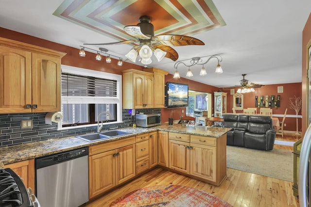 3615 Dragoo Rd, Nashport, OH 43830 - kitchen with decorative backsplash, a ceiling fan, a sink, a peninsula, and stainless steel appliances