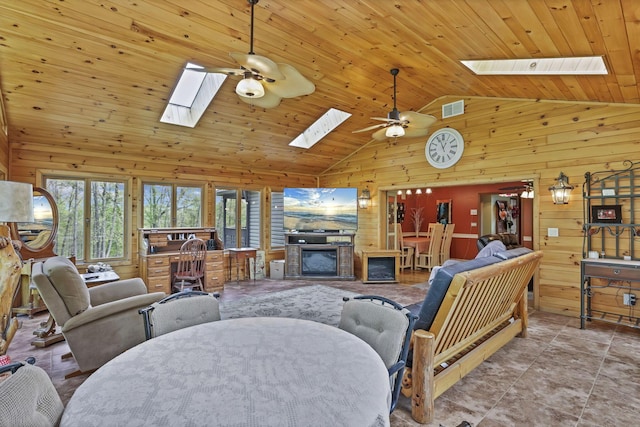 3615 Dragoo Rd, Nashport, OH 43830 - living room featuring wooden walls, a ceiling fan, a skylight, and visible vents