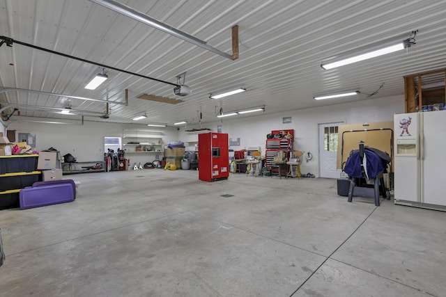 3615 Dragoo Rd, Nashport, OH 43830 - garage with a garage door opener and white fridge with ice dispenser
