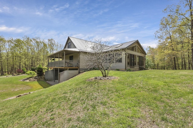 3615 Dragoo Rd, Nashport, OH 43830 - view of property exterior featuring a lawn, a deck, metal roof, and a sunroom