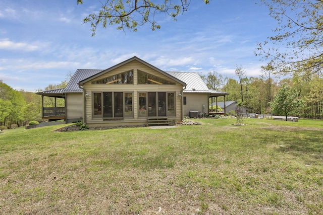 3615 Dragoo Rd, Nashport, OH 43830 - rear view of property with a sunroom, central AC unit, a yard, and metal roof