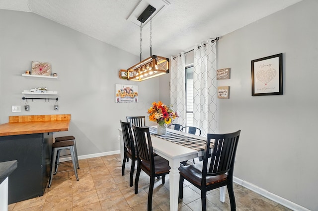 4969 Shannonbrook Dr, Columbus, OH 43221 - dining space with baseboards, a textured ceiling, and vaulted ceiling