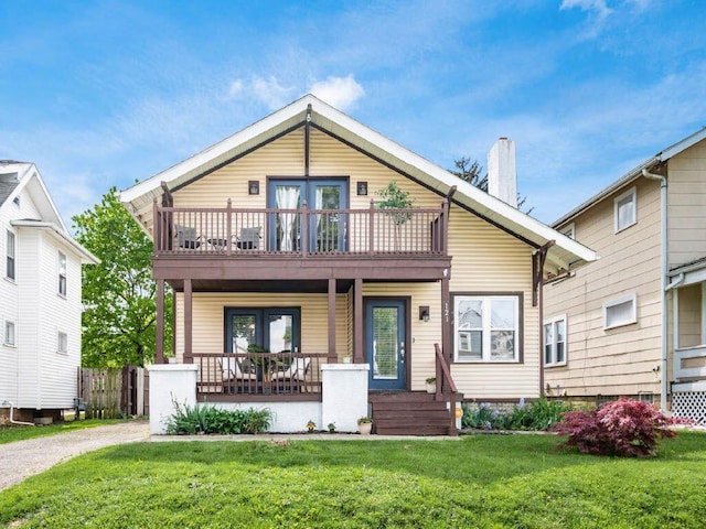 121 Haldy Ave, Columbus, OH 43204 - view of front of property featuring a balcony, french doors, a front yard, a chimney, and a porch