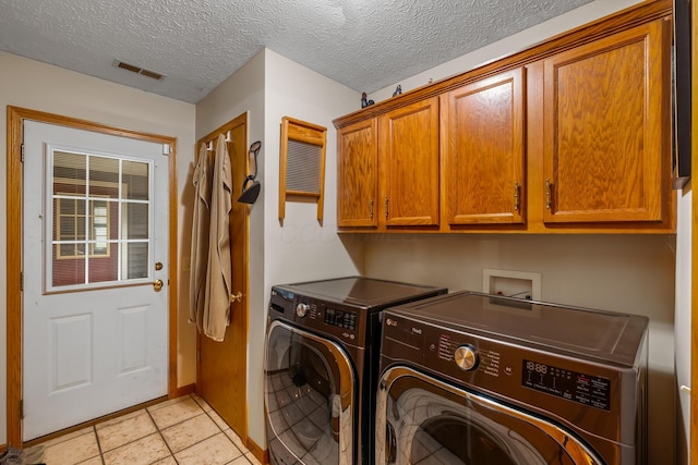 laundry room featuring visible vents, cabinet space, independent washer and dryer, and light tile patterned flooring