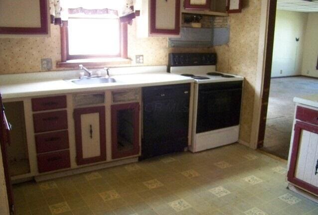 kitchen with a sink, electric stove, black dishwasher, wallpapered walls, and light floors