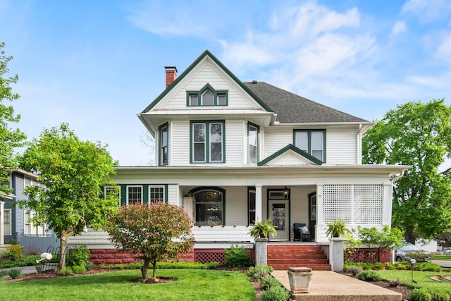6 Town St, Pataskala, OH 43062 - victorian-style house with a chimney, covered porch, a front lawn, and a shingled roof
