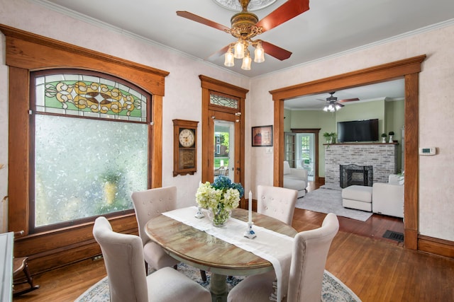 6 Town St, Pataskala, OH 43062 - dining room featuring ceiling fan, wood finished floors, a brick fireplace, crown molding, and baseboards