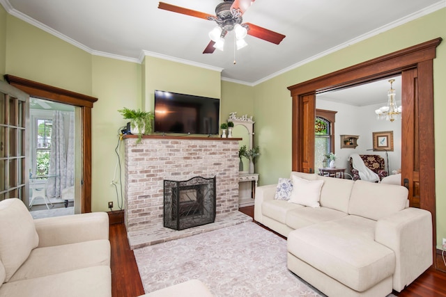 6 Town St, Pataskala, OH 43062 - living room with wood finished floors, crown molding, a fireplace, a ceiling fan, and a chandelier