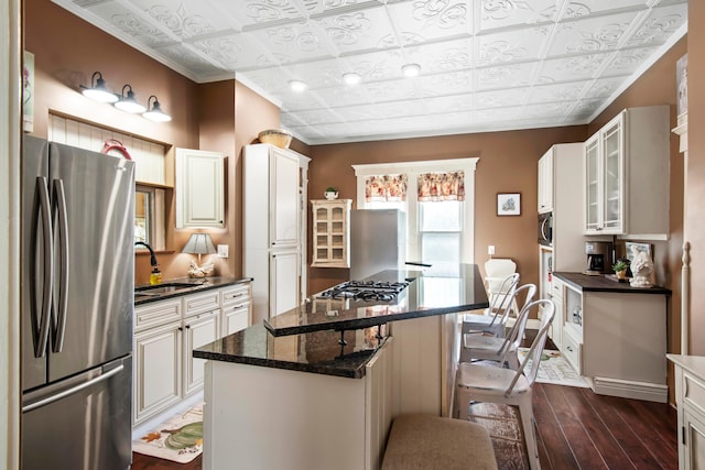 6 Town St, Pataskala, OH 43062 - kitchen with appliances with stainless steel finishes, an ornate ceiling, a sink, a center island, and dark wood-style flooring