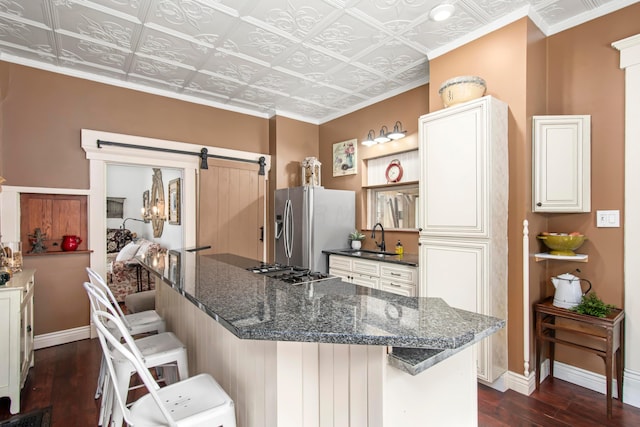 6 Town St, Pataskala, OH 43062 - kitchen with appliances with stainless steel finishes, dark wood finished floors, an ornate ceiling, a breakfast bar area, and baseboards