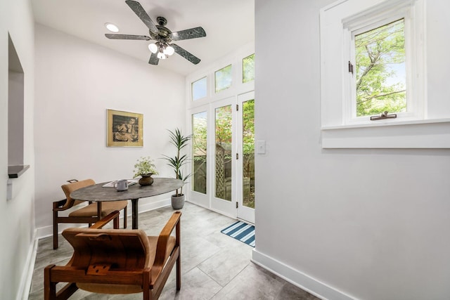 doorway featuring baseboards and a ceiling fan