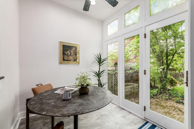 interior space with a ceiling fan and a high ceiling