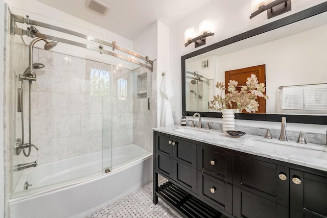 full bath featuring double vanity, a sink, visible vents, and shower / bath combination with glass door