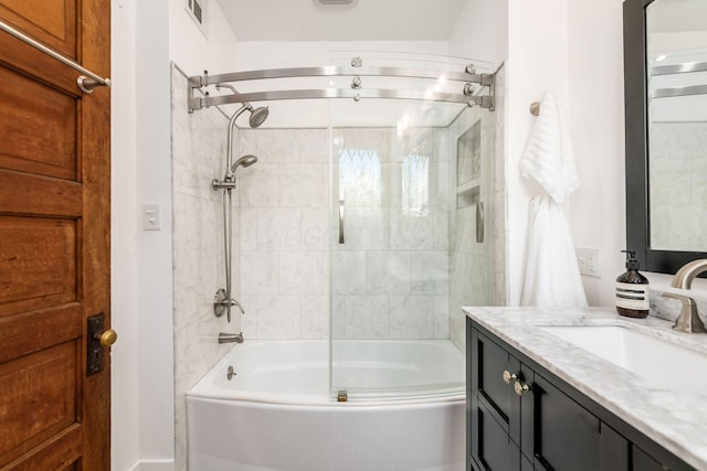 full bathroom featuring visible vents, shower / bath combination with glass door, and vanity