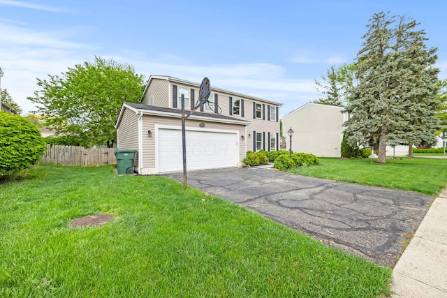 view of front of home featuring fence, a garage, driveway, and a front lawn