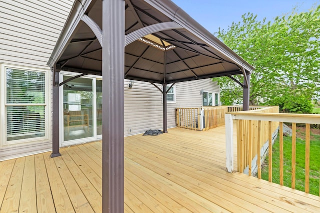 wooden terrace featuring a gazebo