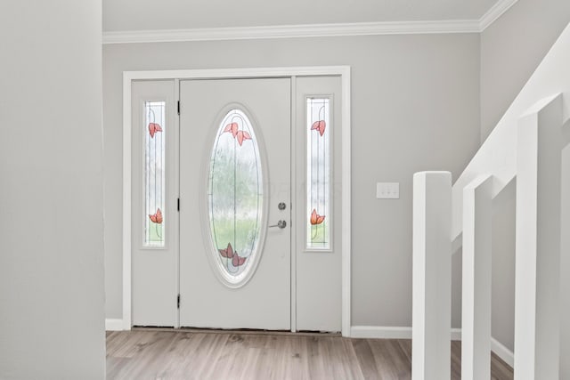 entrance foyer featuring plenty of natural light, ornamental molding, and wood finished floors