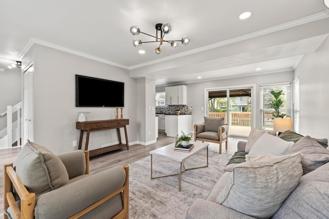 living area with recessed lighting, an inviting chandelier, ornamental molding, and light wood finished floors