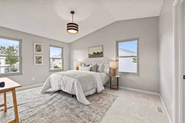 carpeted bedroom featuring baseboards, vaulted ceiling, and visible vents