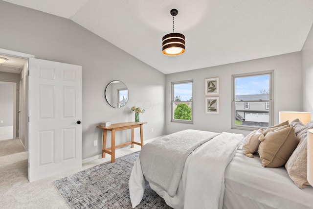 bedroom with carpet floors, baseboards, and lofted ceiling