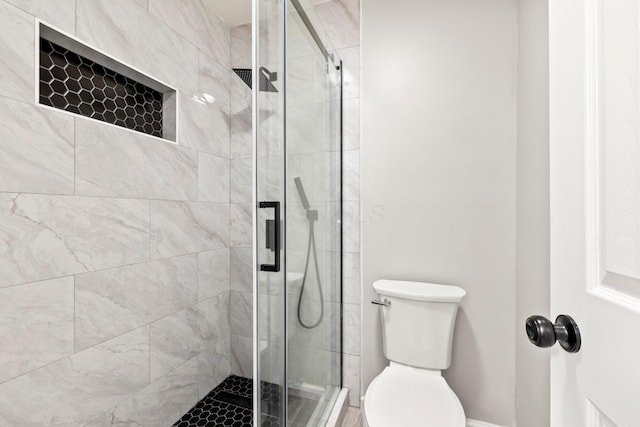 full bath with baseboards, a stall shower, and toilet