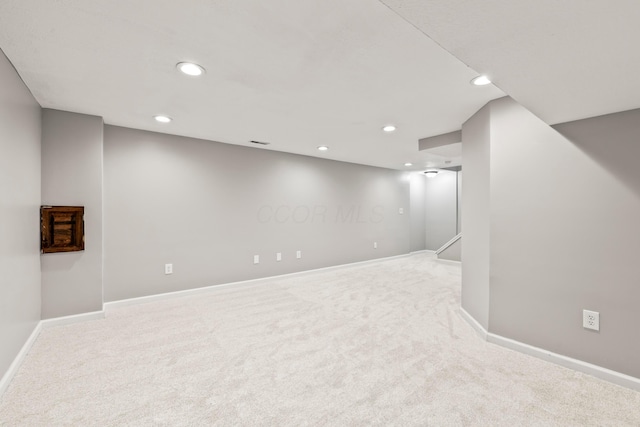 finished basement with carpet floors, baseboards, and recessed lighting