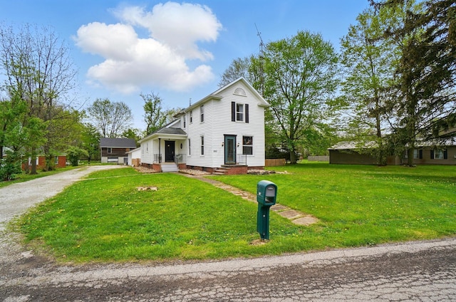 traditional home with a front lawn and driveway
