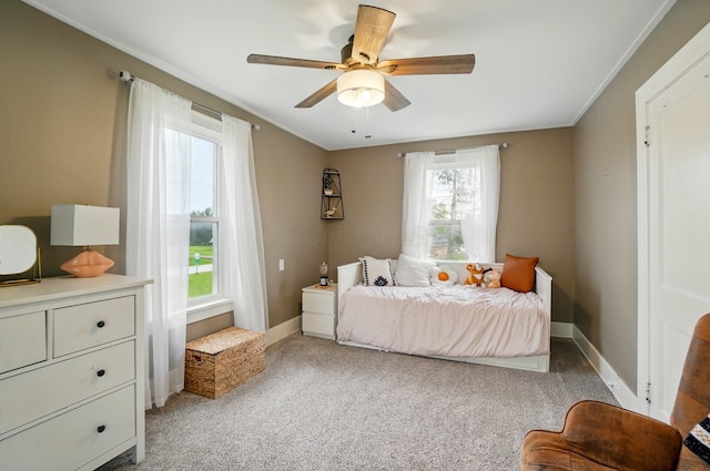 bedroom with baseboards, ornamental molding, ceiling fan, and light colored carpet