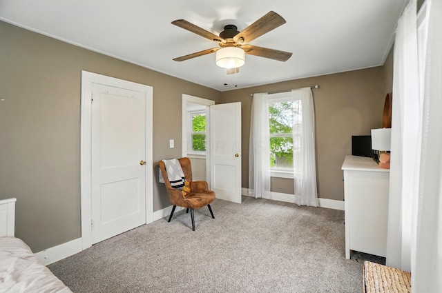 carpeted bedroom featuring baseboards and a ceiling fan