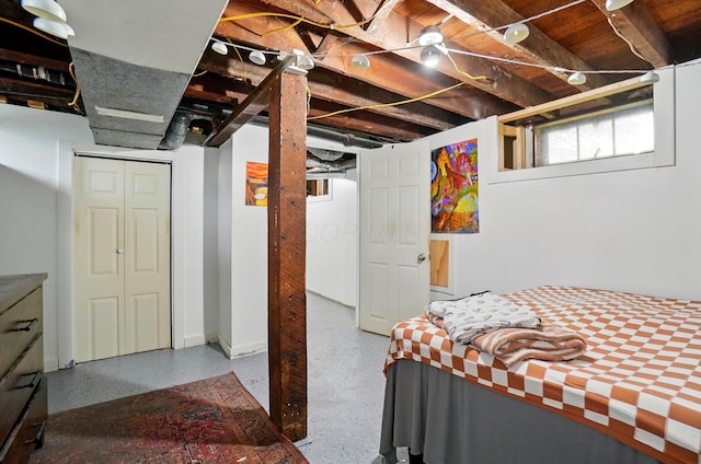 bedroom with baseboards and a closet