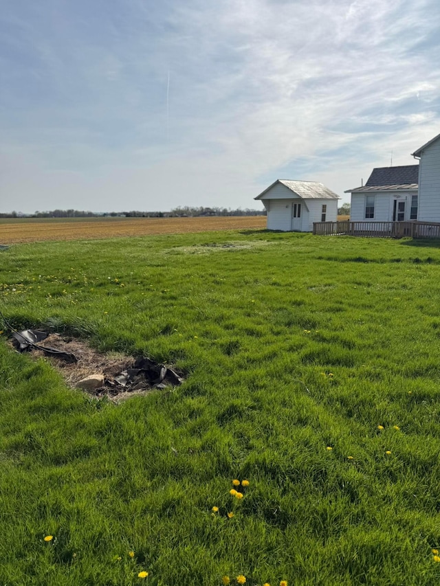 view of yard featuring a rural view and a deck