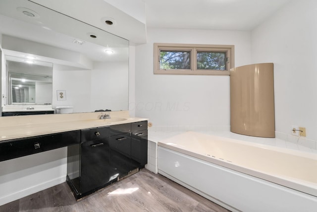 1624 Coppertree Ln, Columbus, OH 43232 - full bathroom featuring wood finished floors, a garden tub, and vanity