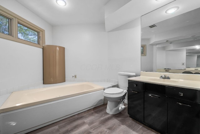 1624 Coppertree Ln, Columbus, OH 43232 - full bathroom with wood finished floors, a garden tub, vanity, and toilet