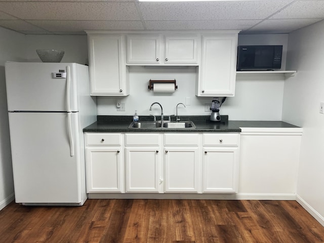 1554 Claudia Ln, Marysville, OH 43040 - kitchen featuring freestanding refrigerator, black microwave, a sink, a paneled ceiling, and white cabinets